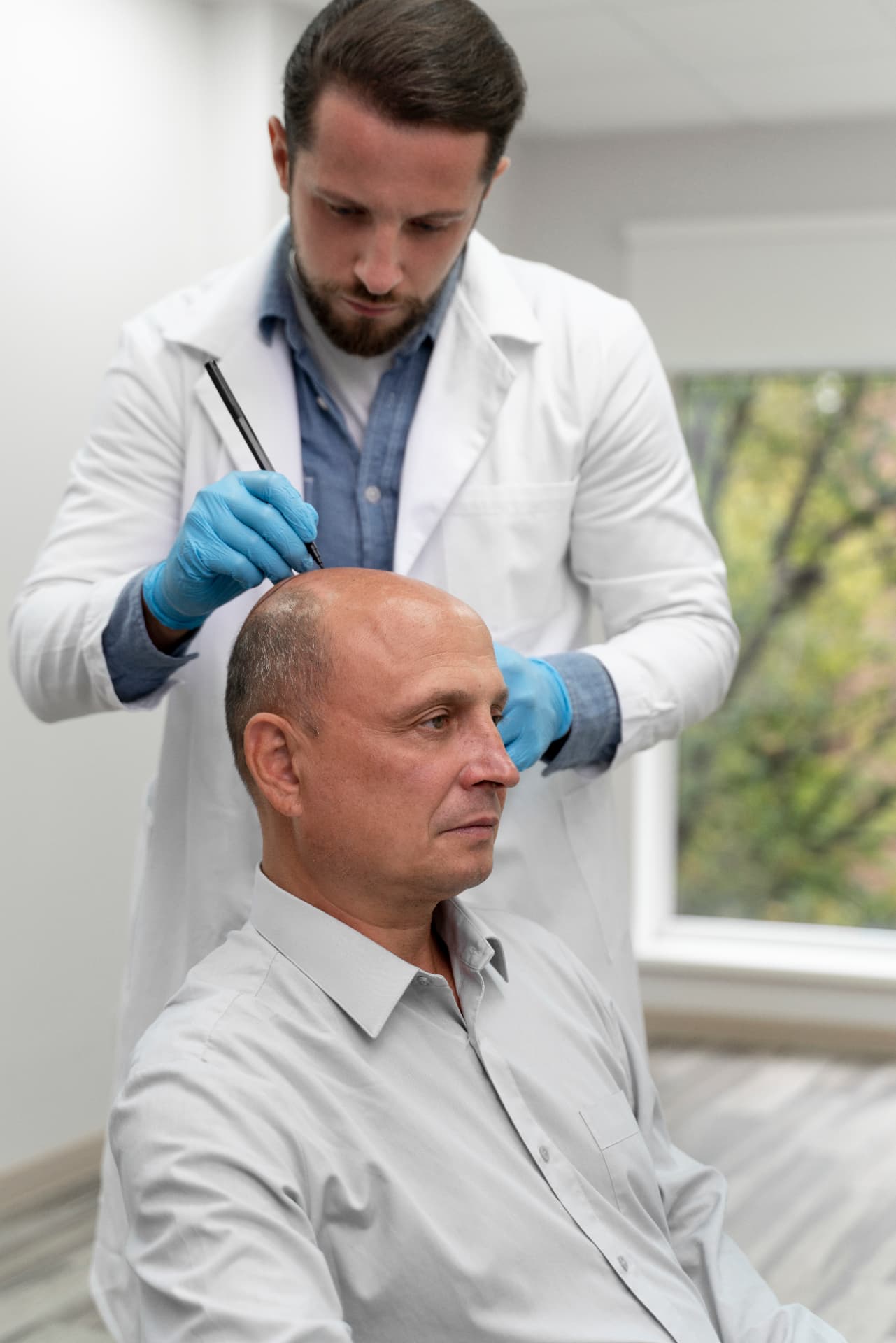 Trichologist marking a patient's scalp during a hair loss assessment